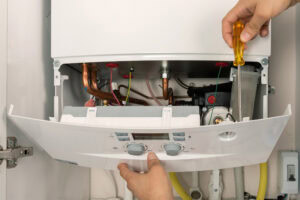 Technician repairing a combi gas boiler.