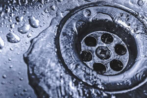 Sink drain with water flowing down.