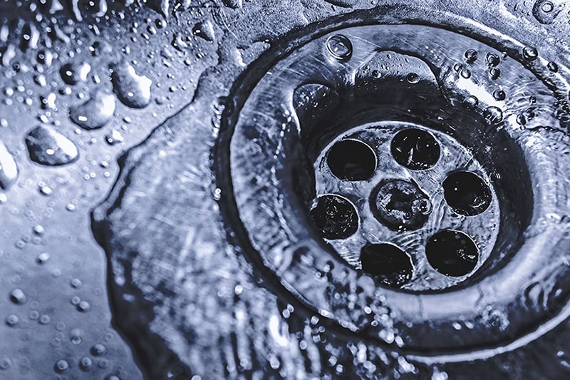 Sink drain with water flowing down.